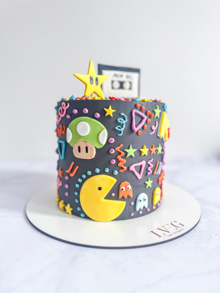 Cake Design sur le thème des années 80-90 noir avec décorations en pâte à sucre et crème